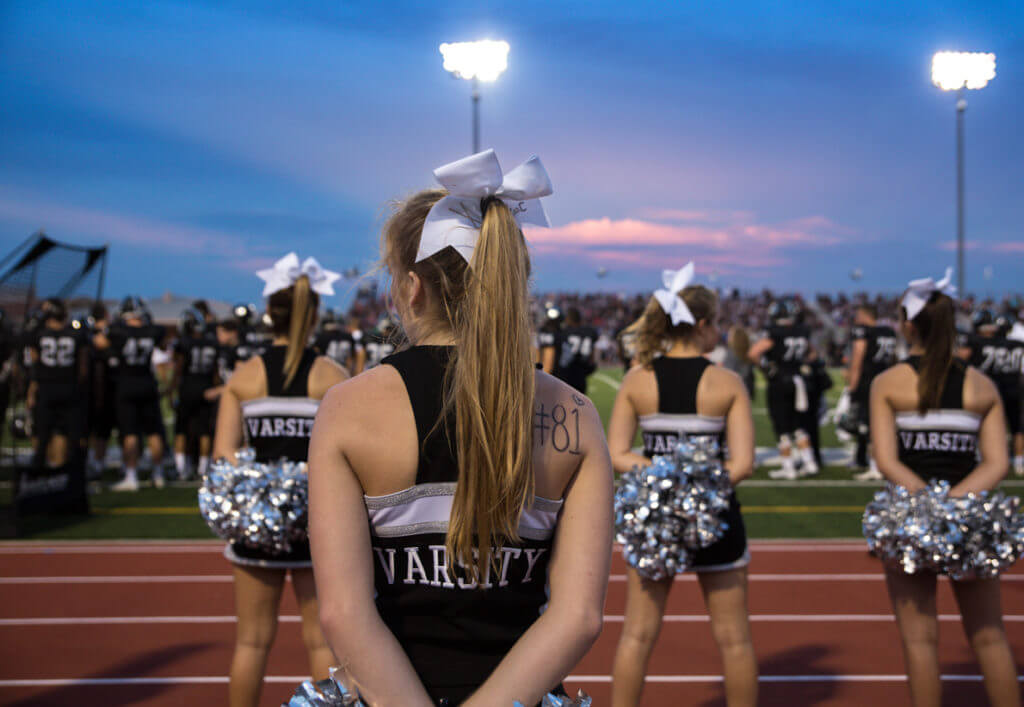 The Vandegrift cheer squad watches the game from the sidelines during a high school football game between the Vandegrift Vipers and the Permian Panthers at Monroe Stadium in Austin, Texas, on August 26, 2016