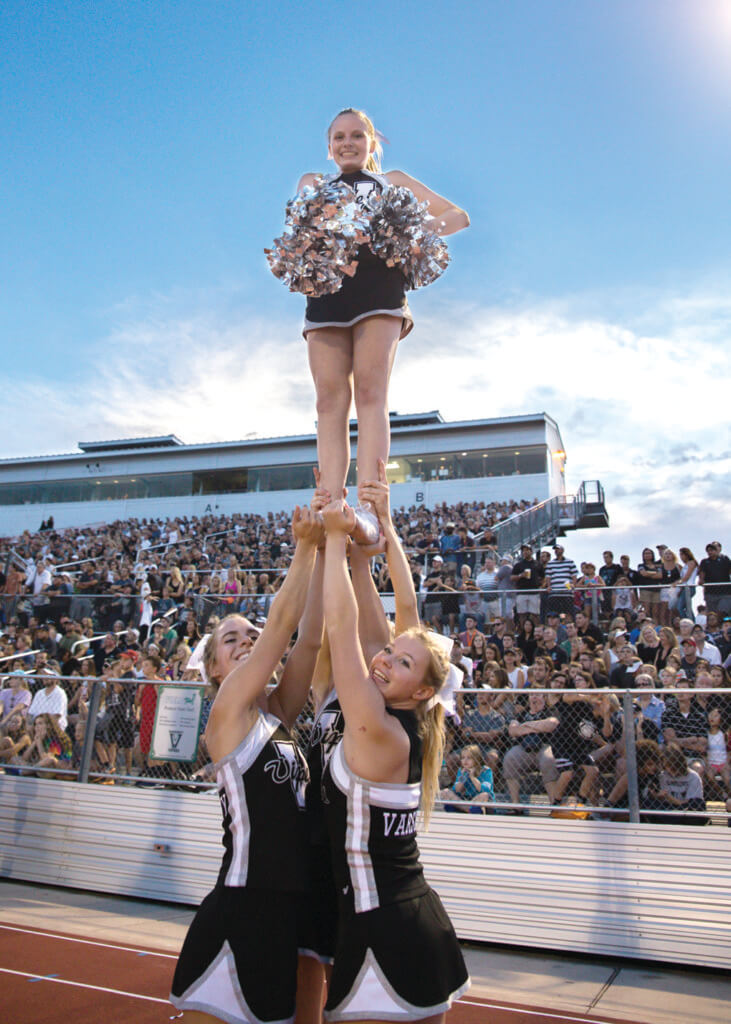 The Vandegrift cheer squad watches the game from the sidelines during a high school football game between the Vandegrift Vipers and the Permian Panthers at Monroe Stadium in Austin, Texas, on August 26, 2016