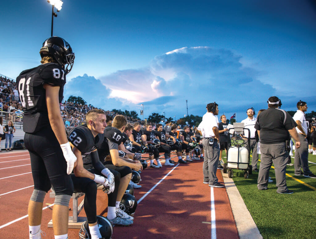The Vandegrift Vipers offense watches the action on the field as storm clouds move in from the north during a high school football game between the Vandegrift Vipers and the Permian Panthers at Monroe Stadium in Austin, Texas, on August 26, 2016