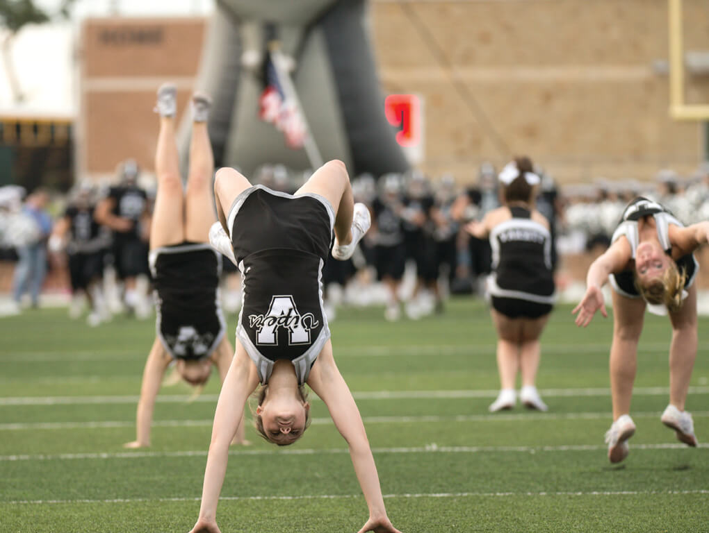 The Vandegrift cheer squad takes the field ahead of the football team to open the season at a home game between the Vandegrift Vipers and the Permian Panthers at Monroe Stadium in Austin, Texas, on August 26, 2016