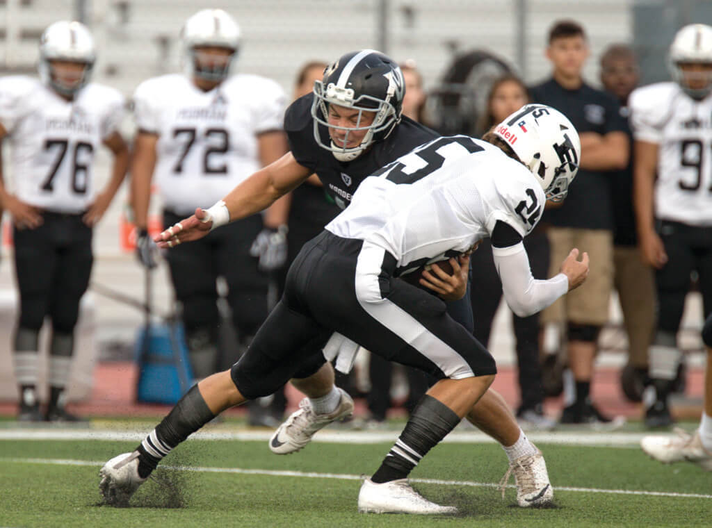 Vandegrift Vipers senior linebacker Storm Wilson (44) brings down Permian Panthers senior quarterback Steve Steen (25) during a high school football game between the Vandegrift Vipers and the Permian Panthers at Monroe Stadium in Austin, Texas, on August 26, 2016