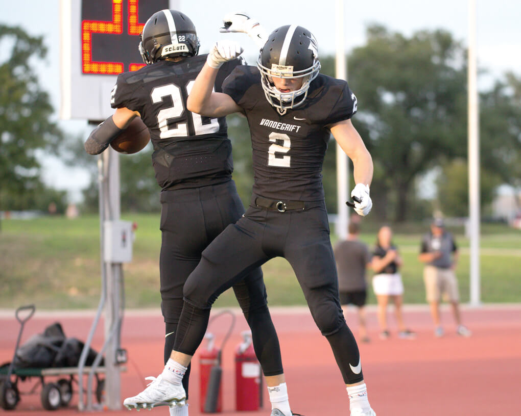 Vandegrift Vipers junior Justin Florence (22) and junior Ben Cross (2) celebrate a touchdown during the first quarter of a high school football game between the Vandegrift Vipers and the Permian Panthers at Monroe Stadium in Austin, Texas, on August 26, 2016
