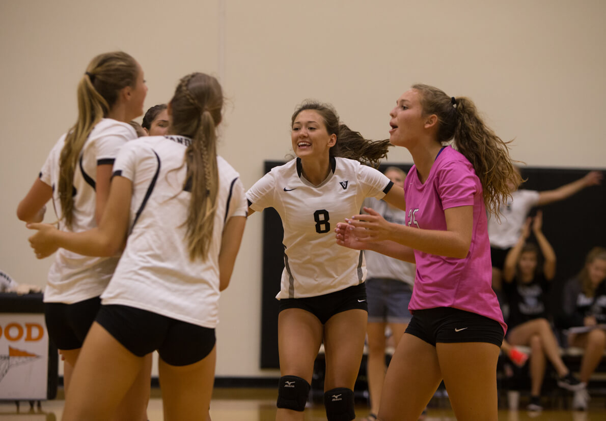 The Vandegrift Vipers celebrate a point during a high school volleyball game between the Vandegrift Vipers and the Cedar Park Timberwolves at Westwood High School in Austin, Texas on August 13, 2016.