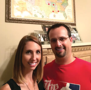 Allison and Robert D’Alfonso with their “love map” showing the states they have already visited on their first seven wedding anniversaries. And even though he’s a Longhorn and she’s an Aggie, “We’re staying married for life,” he said.