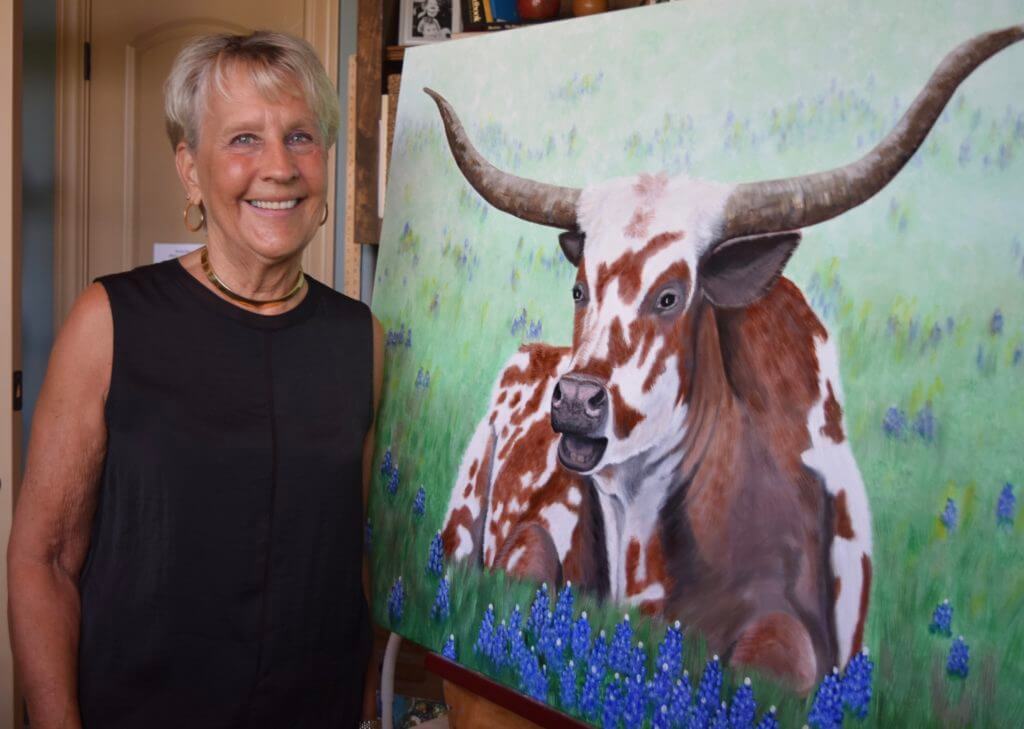 Carol Kneisley, an acrylic painter, is new to Texas and said she finds longhorns to be "magnificent and challenging".