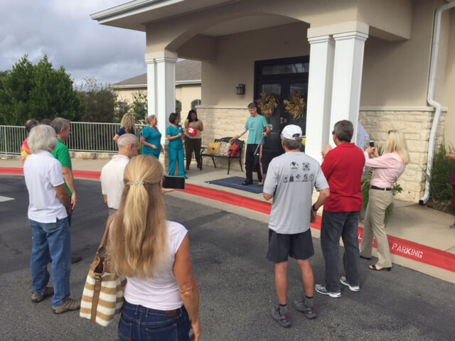Steiner Ranch friends surprise John Holsinger as he walked out of rehab after his 50-foot fall from cycling.