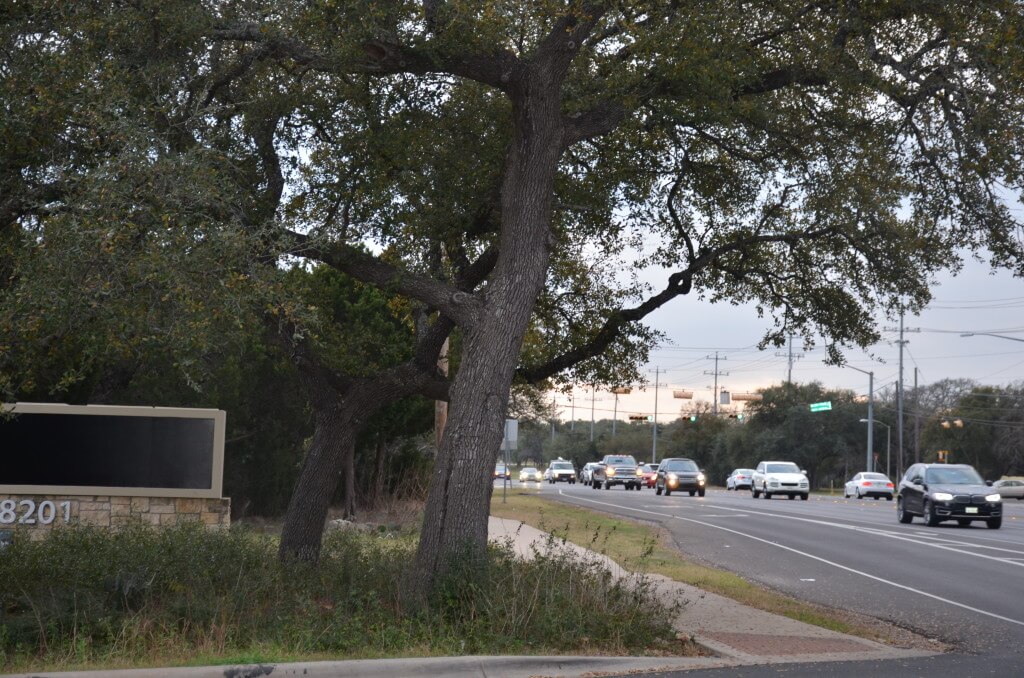 The Hill Country Roadway Ordinance requires that businesses along RM 620 keep a 100-foot vegetative buffer in between the business and the roadway. The Walmart at 8201 RM 620, where this sign is, was an example of a business with a good vegetative buffer but it closed its doors Jan. 28 citing low sales as one of the factors. Photo by Lynette Haaland