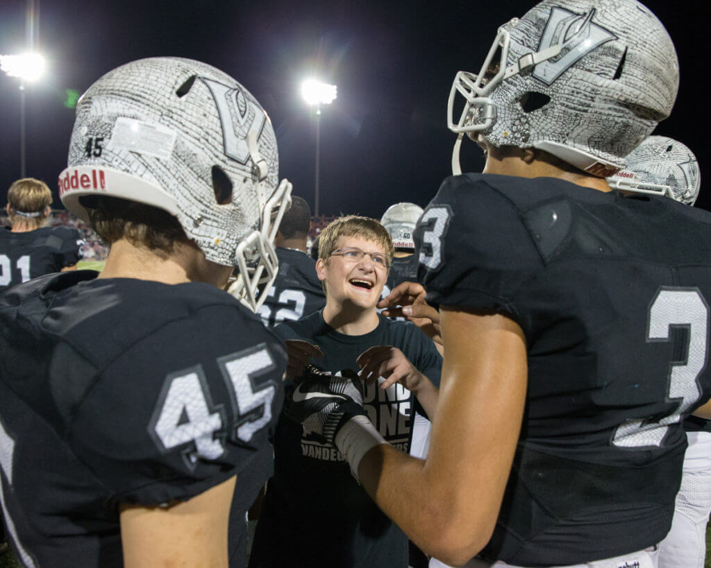 Senior kicker Owen Winterburg (45) and senior quarterback Alex Fernandes (3) share a laugh with Chris Lucido (center) on the sidelines during the second half of a high school football game between the Vandegrift Vipers and the Hays Rebels at Monroe Stadium in Austin, Texas, on October 28, 2016.