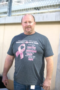 Vandegrift High School Principal Charlie LIttle shows off his t-shirt on a 'Pink Out' night in support of breast cancer awareness during a high school football game between the Vista Ridge Rangers and the Vandegrift Vipers at Gupton Stadium in Cedar Park, Texas, on October 14, 2016.