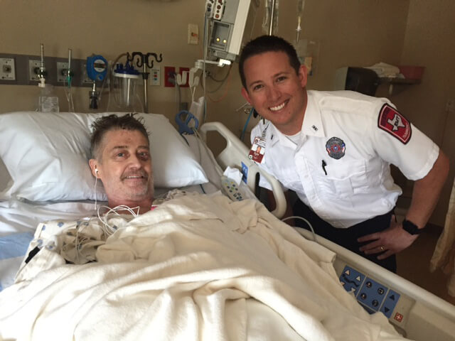 Kyle McKnight, Williamson County EMT and first responder to site of John Holsinger’s recent bicycle accident, visits him in the hospital. Holsinger fell approximately 50 feet off of a bridge in Georgetown on Labor Day. 