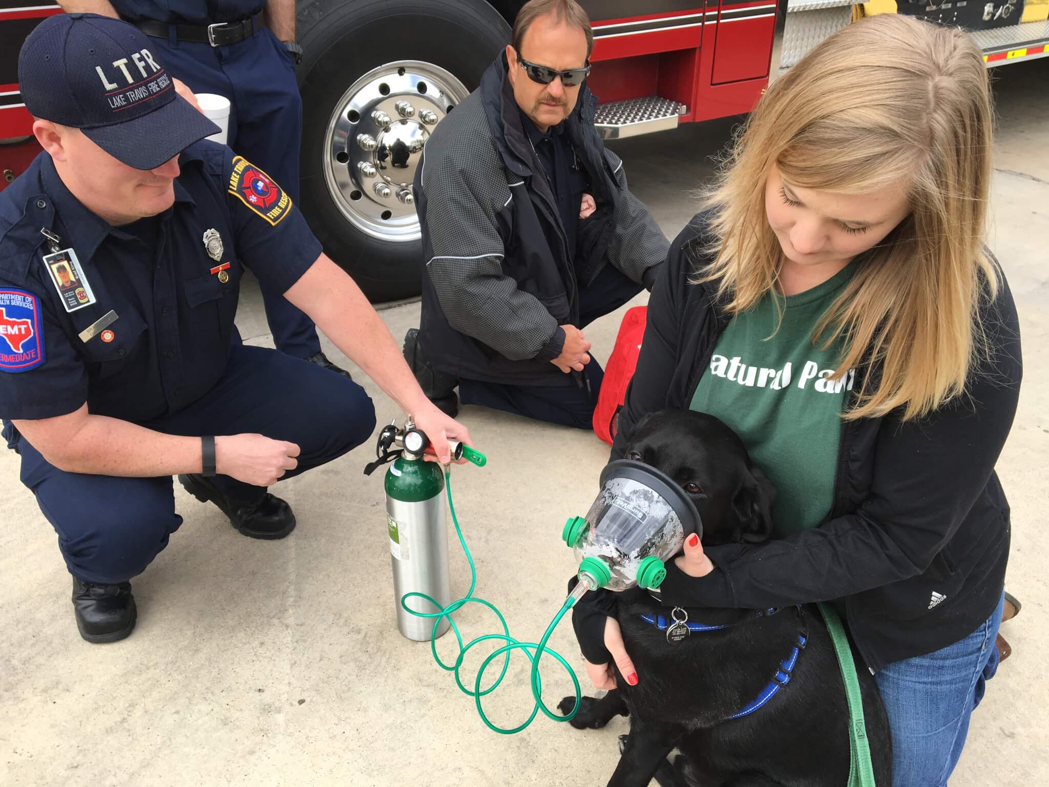 Natural Pawz Steiner Ranch donated five pet oxygen mask kits to Lake Travis Fire Rescue, ensuring that all five stations of the Travis County Emergency Services ESD 6 have enough in-use and back-up equipment to help save pets rescued in house fires. Kelly Green, manager of the new local store which is to open on Saturday, shows how the masks work with her Labrador Buddy.