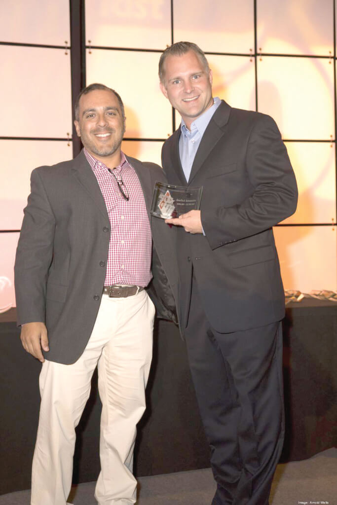 QualTech Automotive owner Billy Leavings (right) in a photos with Derek Castillo of Castleview Productions at the 2016 Fastest-Growing Companies in Central Texas awards ceremony.