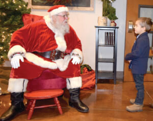 Patrick Moxon keeps a friendly distance from Christmas’ biggest and bearded elf.