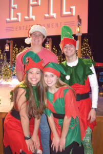 Santa’s helpers (L-R front) McLendon Hall and Jennifer Stewart and (back) Hunter Parks and Talen Rose help keep things in order for Santa.