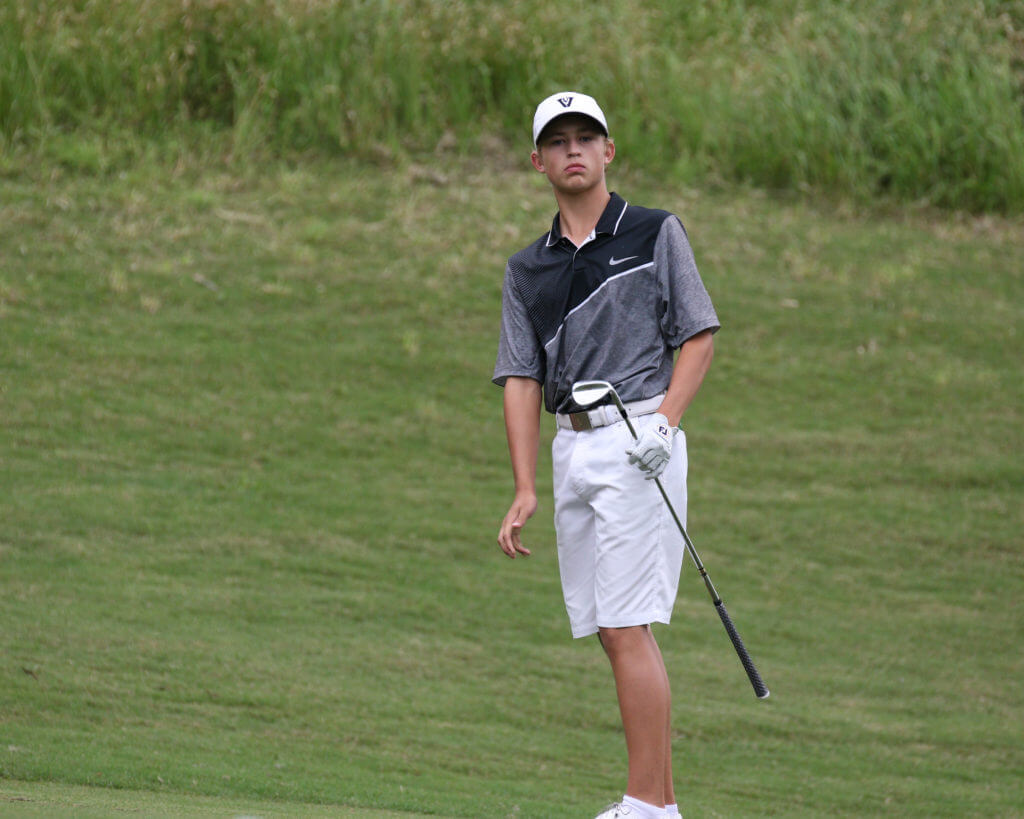 Luke Dossey of Vandegrift High School watches an approach shot hit the green at the UIL Class 5A state golf tournament at Wolfdancer Golf Club in Cedar Creek.