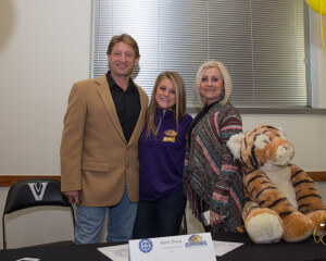 Vandegrift High School senior soccer player Kylie Sharp enjoys a moment with her parents on National Signing Day, Feb. 3, 2016. Sharp signed a commitment to attend Ouachita Baptist University.